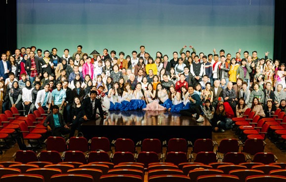 Group photo of international students on stage
