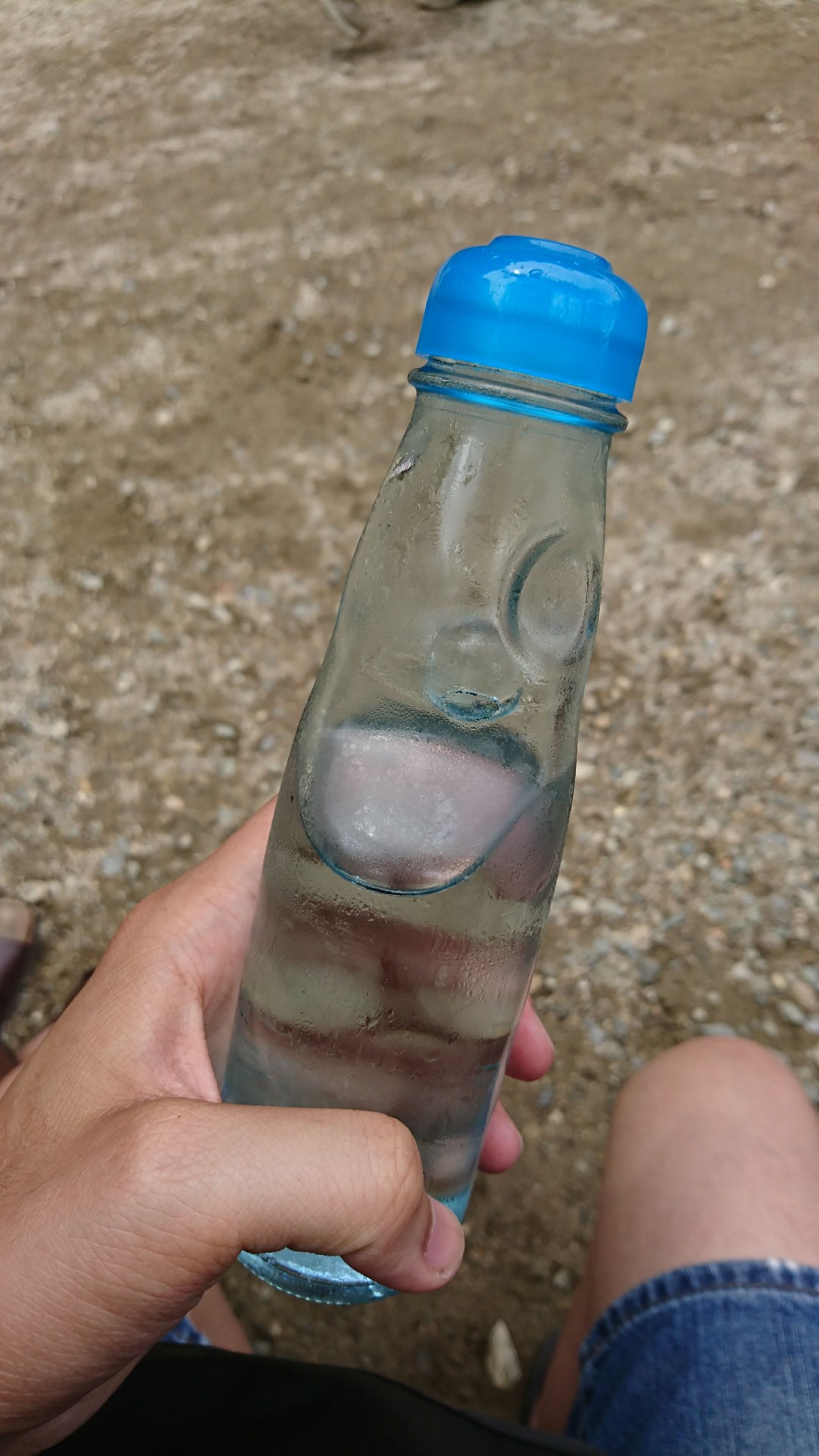 Holding Ramune (a lemon-lime flaboured carbonated soft drink in Japan) bottle in my hand.