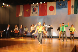A group of students standing on stage hosting an event.