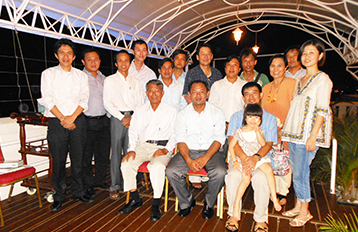 Group photo of former international students at a terrace.