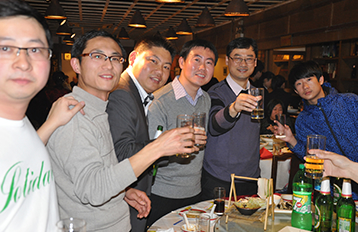 Former international students at a party enjoying drinks together.