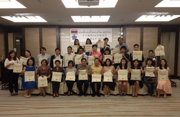 Group photo of former international students indoors.